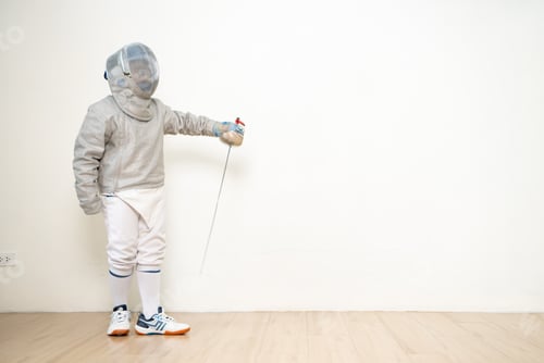 Preview: Before the tournament day, a boy dressed in fencing gear are rehearsing in gym