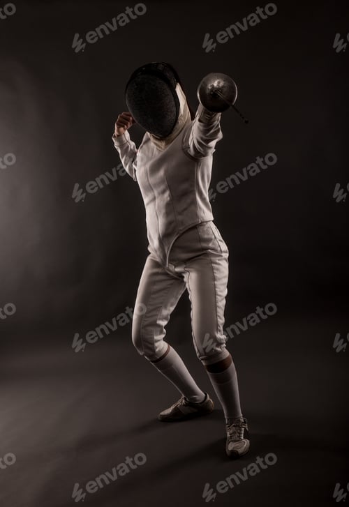 Preview: Portrait of woman wearing white fencing costume practicing with the sword.