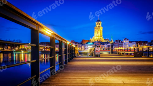 Preview: Scenic view of the town of Deventer along a river in the Netherlands at night