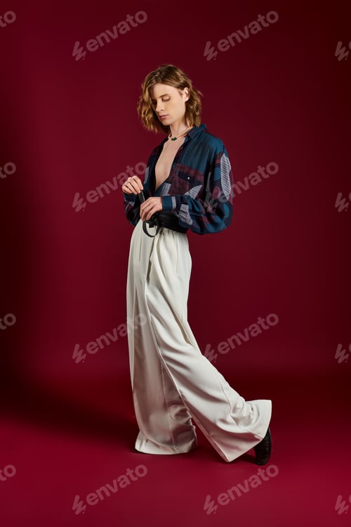 Preview: Strikingly elegant man showcases unique fashion sense in vibrant studio setting