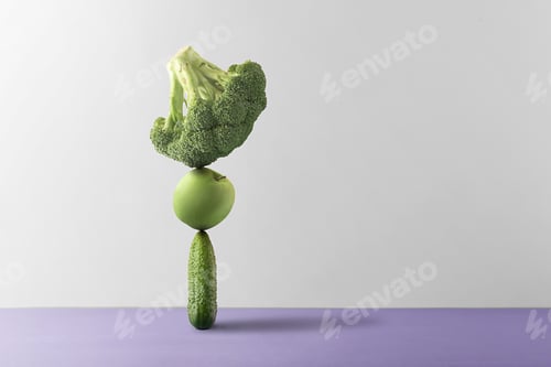 Preview: Concept of nutritional balance. Fresh fruits and vegetables are balanced against a gray background.