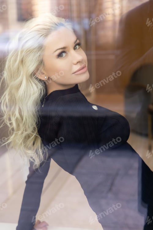 Vista previa: Beautiful blond woman with evening makeup, long waved hair, posing