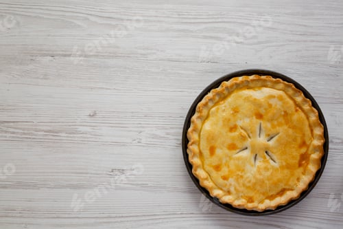Preview: A Piece of Chicken Pot Pie on a white wooden background, top view. Flat lay, overhead, from above.