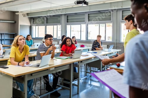 Preview: Young group of diverse high school students giving a presentation in classroom
