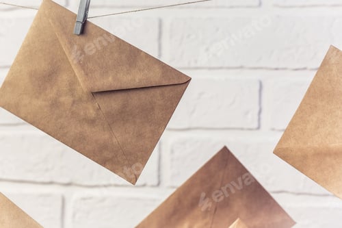 Preview: Blank kraft paper envelope hanging, communication concept in retro style, postal background