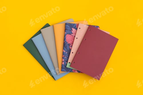 Preview: Notebooks on yellow background. Top view. Flat lay. Back to school concept.