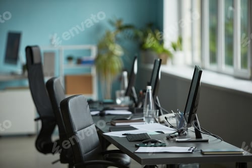 Preview: Empty Modern Office Workspace Featuring Computers and Documents on Desk