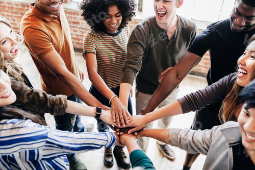 Preview: Group of diverse people stacking hands in the middle