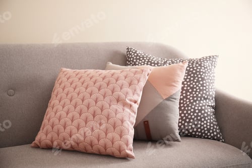 Preview: Different soft pillows on sofa in room