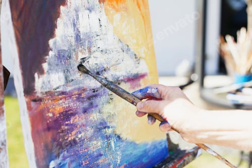 Preview: Cropped image of senior female artist painting canvas outdoors