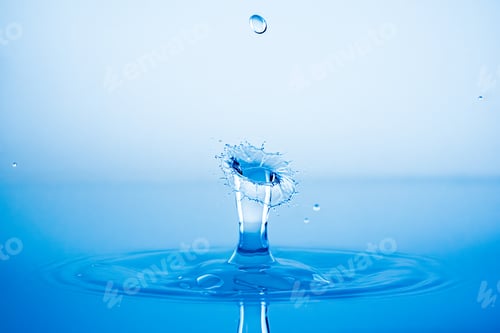 Preview: Water drop splashing into blue water surface