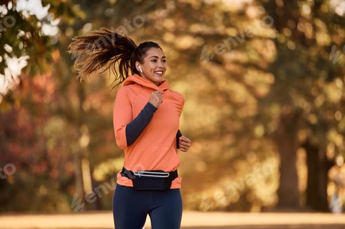 Motivated female athlete jogging in the park.