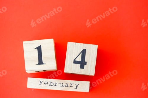 Preview: Wooden calendar with the date of February 14 on a bright red background. Romantic date. Valentine's
