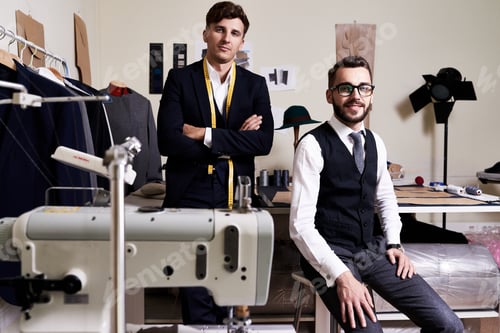 Preview: Men Pose in Tailor Shop with Sewing Machine