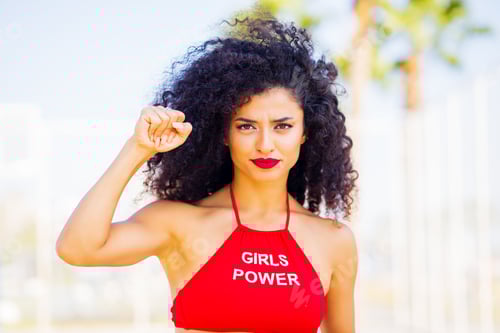 Preview: Empowered Woman Posing with Confident Expression Outdoors