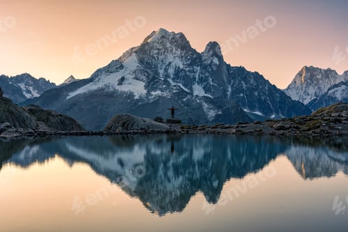 Preview: Landscape of Lac Blanc with Mont Blanc massif with male traveler on the lake at Chamonix, France