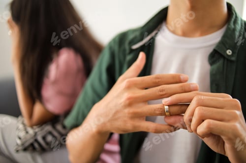 Preview: Relationship on the verge of collapse as husband removes ring in hand beside unhappy partner.