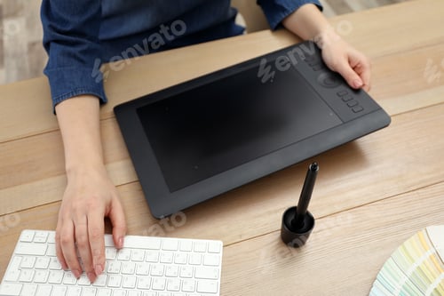 Preview: Professional designer working on graphic tablet at desk, closeup