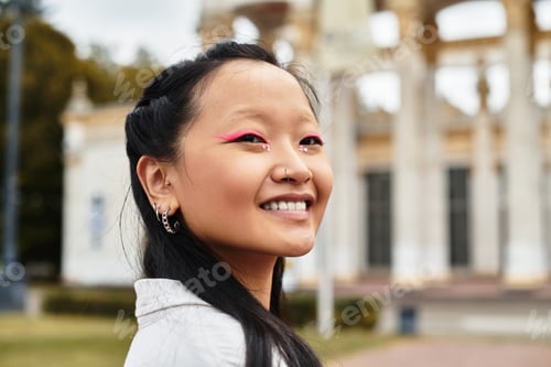 Preview: A lively young Asian student embraces campus life with style on a sunny afternoon