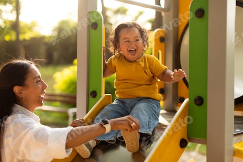 Preview: Japanese Mother Riding Baby Daughter Down The Slide At Playground