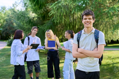 Preview: Portrait of male student in park campus, group of teenagers with teacher background