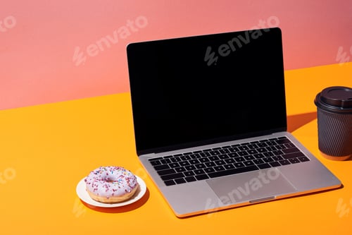 Preview: laptop with blank screen near donut and paper coffee cup on yellow surface and pink background