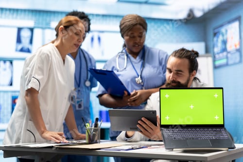 Preview: Doctors and nurses review radiography scans with a green screen on desk