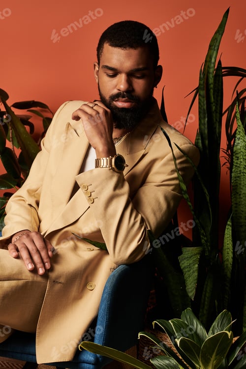 Preview: Charming young man in stylish summer attire relaxing amidst vibrant greenery