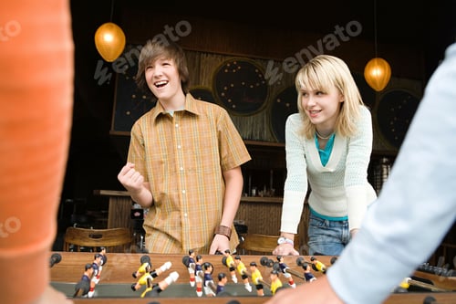 Preview: Four teenagers playing table football