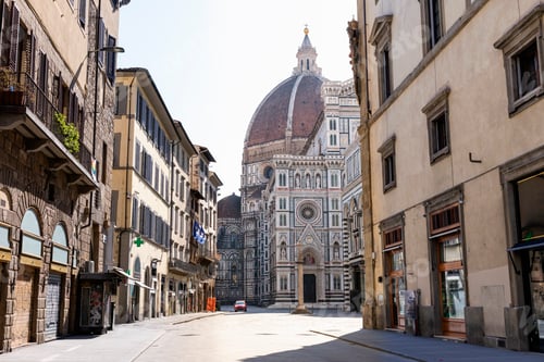 Preview: A quiet morning on an old European street with a view of the iconic cathedral dome in the background