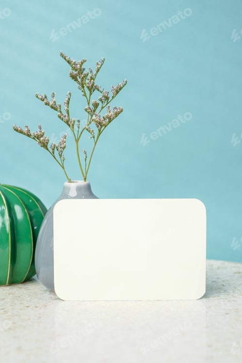 Preview: blank poster paper card with flower vase and cactus decor on stone table wtih blue background