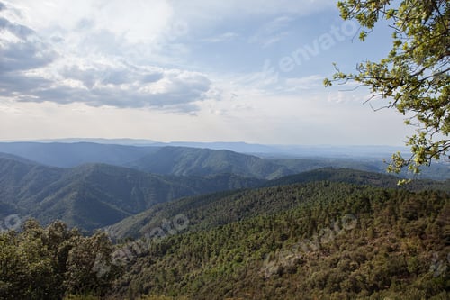 Preview: Rolling green mountain range beneath a blue sky