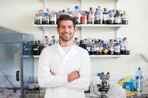 Preview: Confident scientist smiling in a laboratory with arms crossed