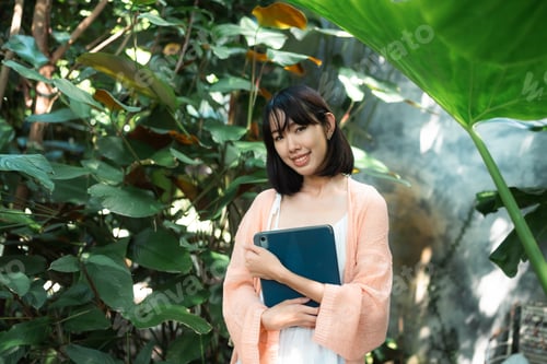 Preview: Cyberspace, Asian Female Entrepreneur Embraces Freelance Lifestyle, Working Happily from Home Garden