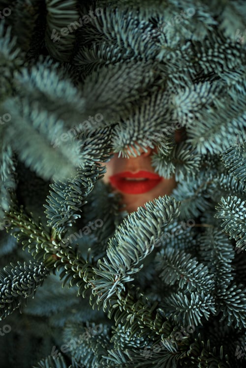 Preview: Women's face covered with nobilis branches