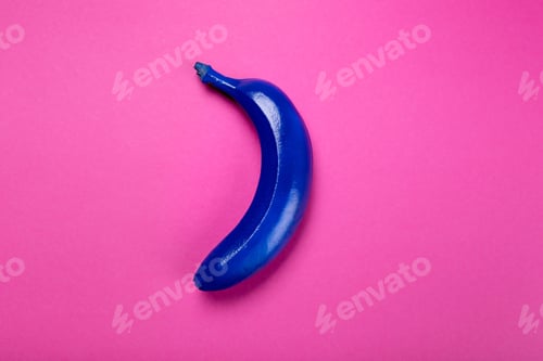 Preview: Top view of blue colored banana isolated on pink, colorful background