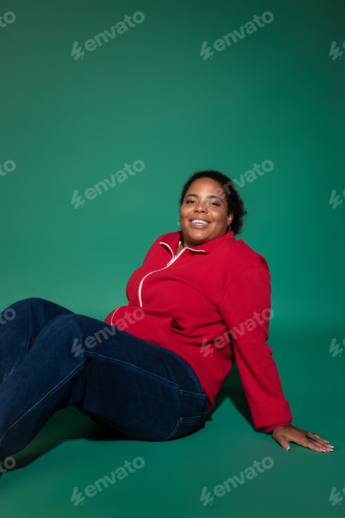 Preview: Stylish plus size african american woman showcasing autumn fashion in studio