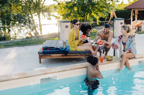 Preview: Friends eating watermelon by the poolside during summer vacation