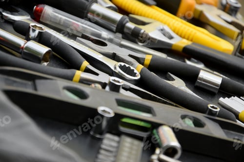 Preview: Handyman tool kit on black wooden table. Many wrenches and screwdrivers