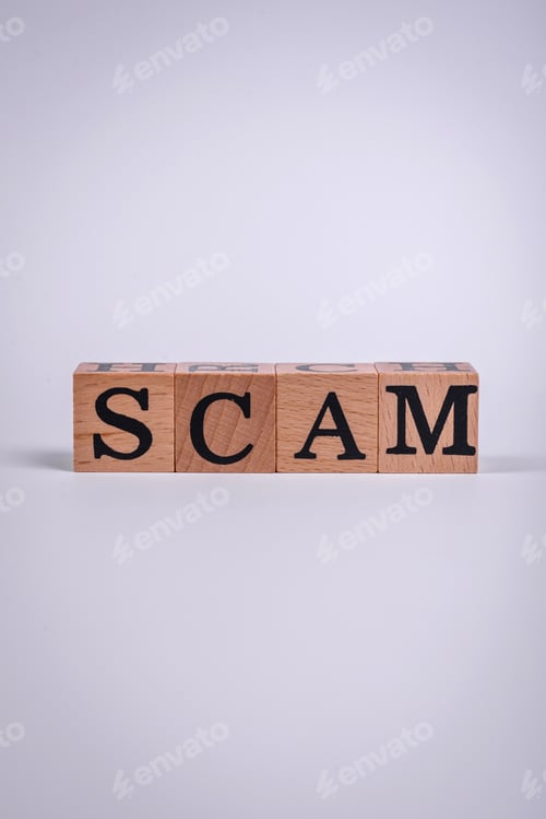 Preview: The inscription Scam made of wooden cubes on a plain background