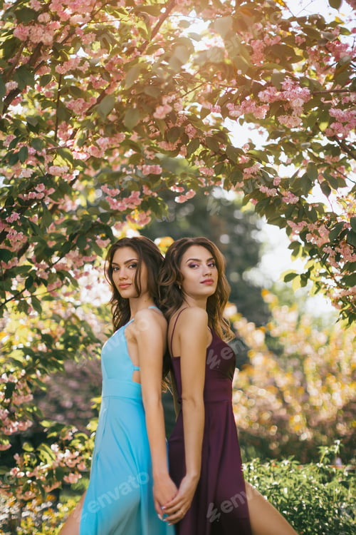 Preview: Fashion Portrait Photo of Two Women Near Blossoming Tree on Nature