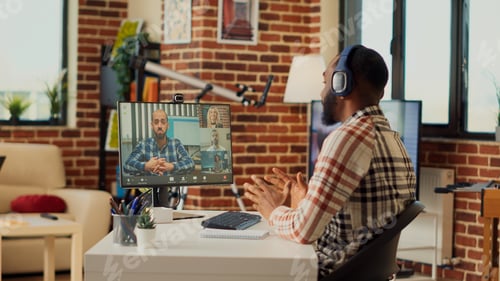 Preview: Male employee talking to people on online videocall conference