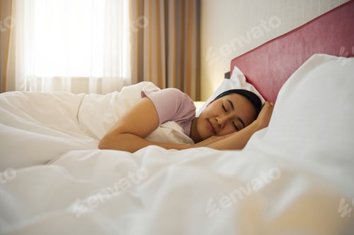 Preview: Tranquil Asian woman sleeping in her bedroom in morning