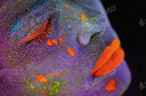Preview: Living life in color. Shot of a young woman posing with neon paint on her face.