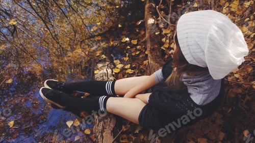 Preview: Young woman enjoy the autumn in a park