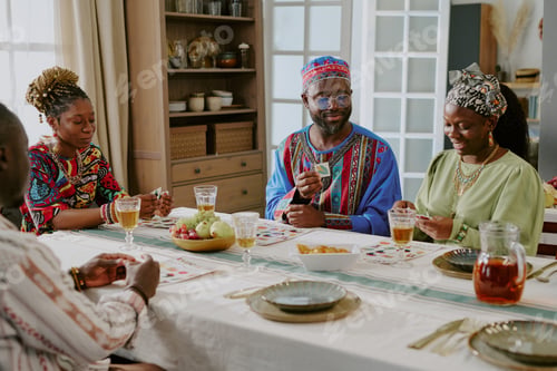 Preview: Group of Black Adults Celebrating Kwanzaa and Sharing Traditional Meal Together