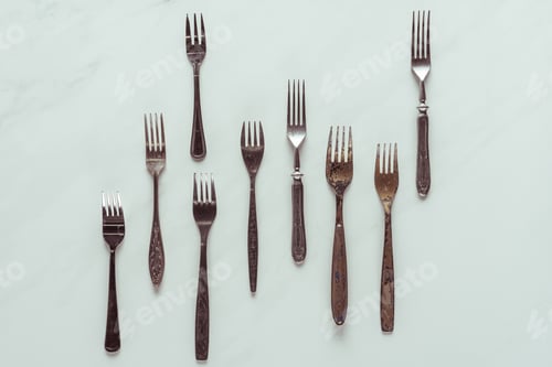 Preview: Set of vintage rusted forks on white background