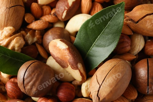 Preview: Different tasty nuts on whole background, close up