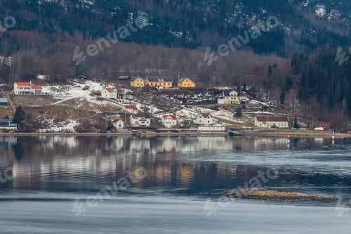 Preview: Scenic view of a tranquil Norwegian village nestled by the water with snow-covered hills