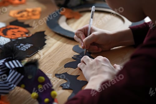Vista previa: Teen boy making Halloween decor for home celebrating. DIY or crafting concept
